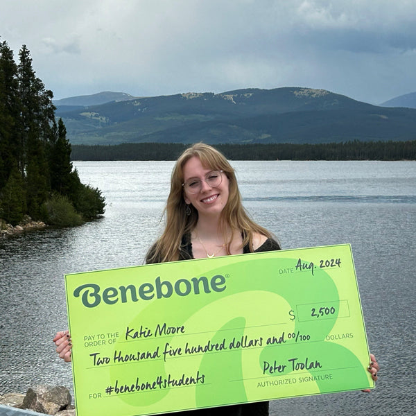 Benebone Scholarship recipient Katie Moore holding a giant green check.