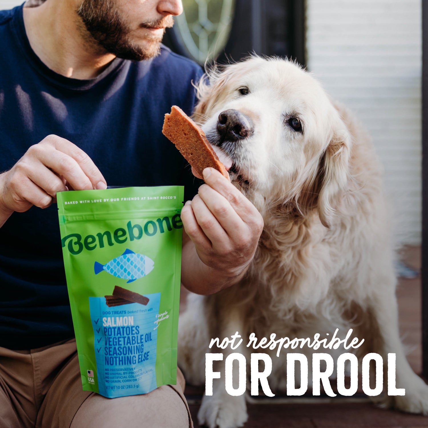 Not Responsible for Drool: A Golden Retriever (a large-breed long-haired dog with a yellow coat) licks a Benebone Salmon Dog Treat that its owner is holding fresh out of the bag.